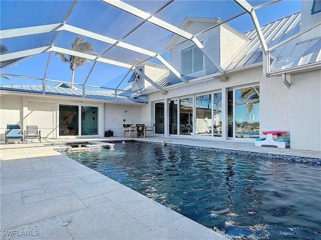 view of swimming pool with glass enclosure and a patio area