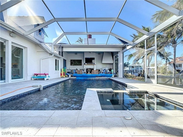 view of swimming pool featuring a lanai, a patio area, and an in ground hot tub