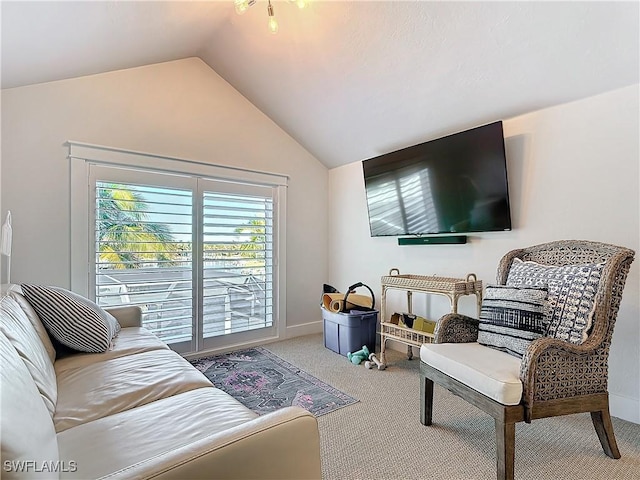 carpeted living room featuring lofted ceiling