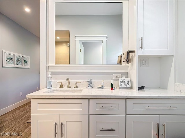 bathroom with vanity and hardwood / wood-style flooring