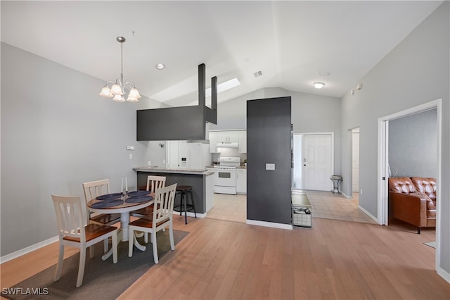 kitchen featuring white appliances, light hardwood / wood-style flooring, white cabinetry, a breakfast bar area, and a chandelier