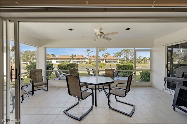 sunroom featuring ceiling fan