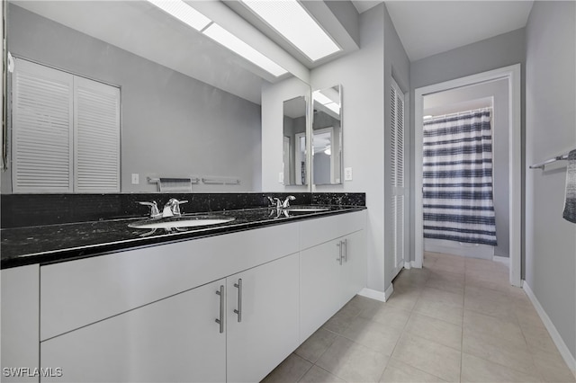 bathroom featuring a shower with curtain, tile patterned flooring, and vanity