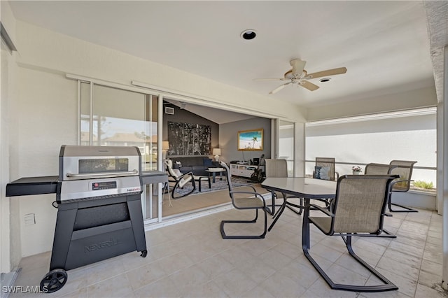 dining area with ceiling fan, light tile patterned flooring, and lofted ceiling