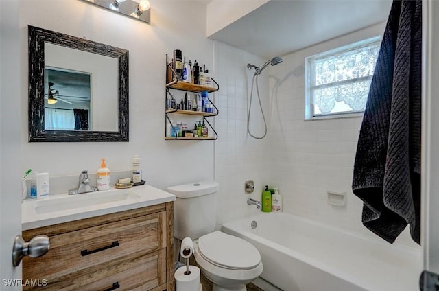 full bathroom featuring ceiling fan, tiled shower / bath combo, vanity, and toilet