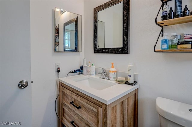 bathroom featuring vanity and toilet