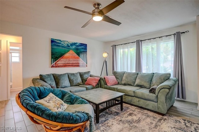 living room featuring ceiling fan, hardwood / wood-style floors, and a wealth of natural light