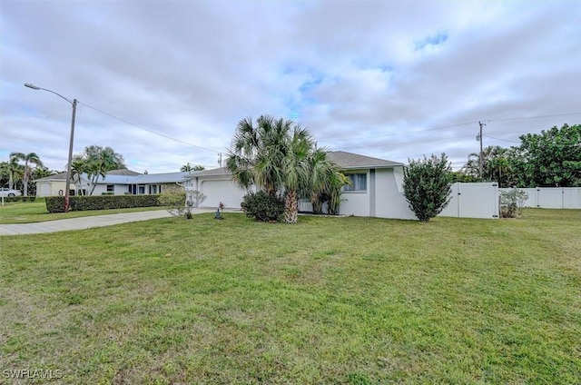 view of front of home with a garage and a front yard