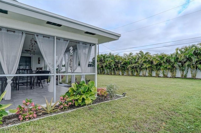 view of yard featuring a patio and a sunroom