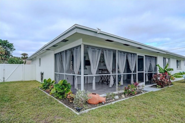 rear view of property with a patio area and a lawn