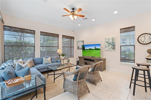 living room featuring ceiling fan, light tile patterned floors, and ornamental molding