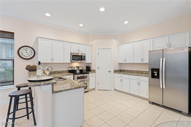 kitchen featuring appliances with stainless steel finishes and white cabinetry