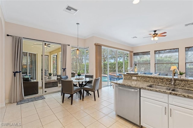 kitchen featuring dishwasher, stone counters, sink, white cabinetry, and decorative light fixtures