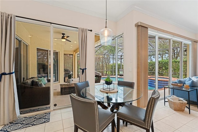 tiled dining area featuring ceiling fan and crown molding