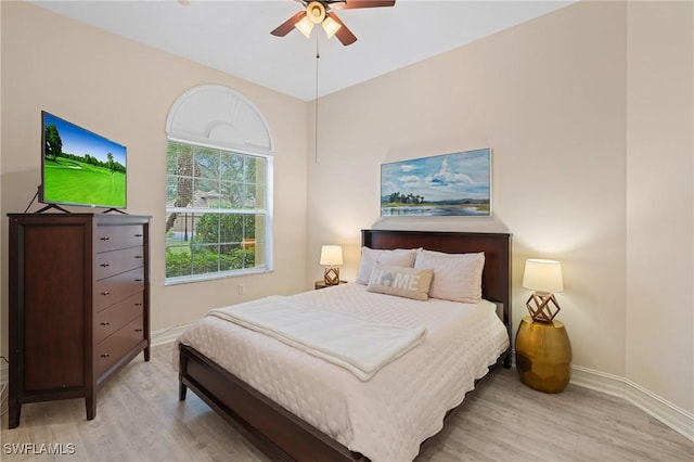 bedroom with ceiling fan and light hardwood / wood-style flooring