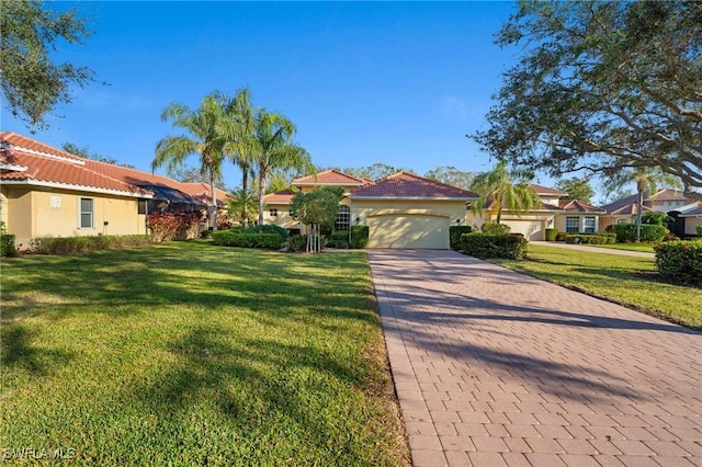 view of front of property featuring a garage and a front yard