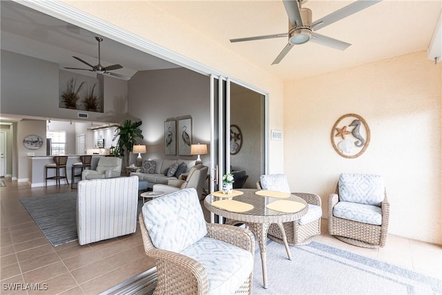 interior space with an outdoor living space and a ceiling fan