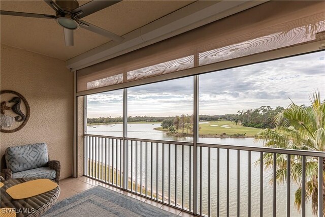 sunroom / solarium featuring a water view