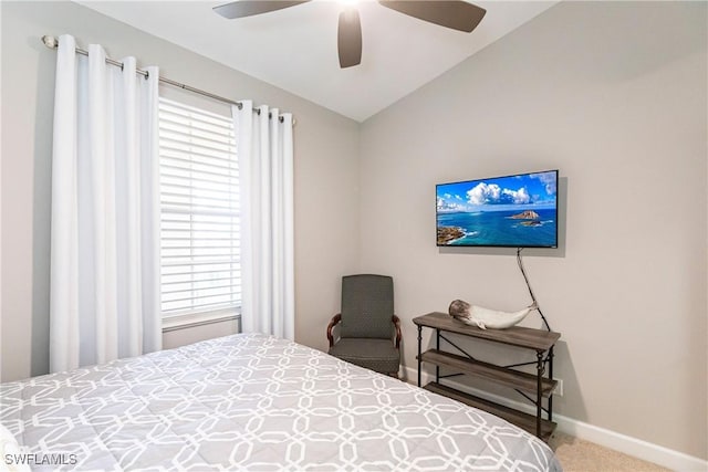 carpeted bedroom with ceiling fan, baseboards, and vaulted ceiling