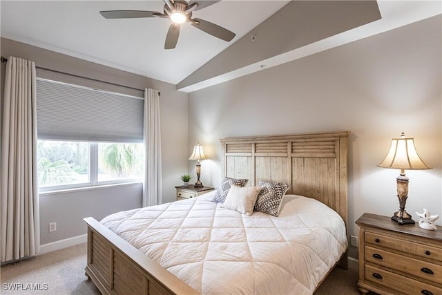 carpeted bedroom featuring baseboards, lofted ceiling, and a ceiling fan