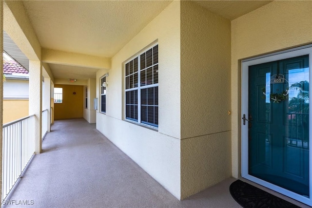 doorway to property featuring stucco siding