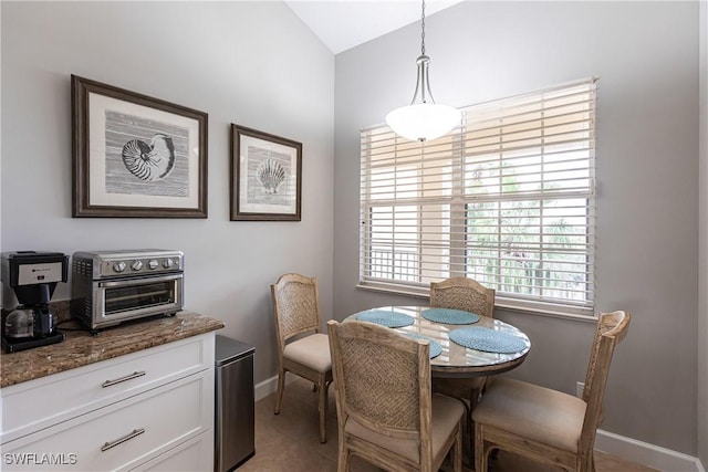 dining room featuring a toaster and baseboards