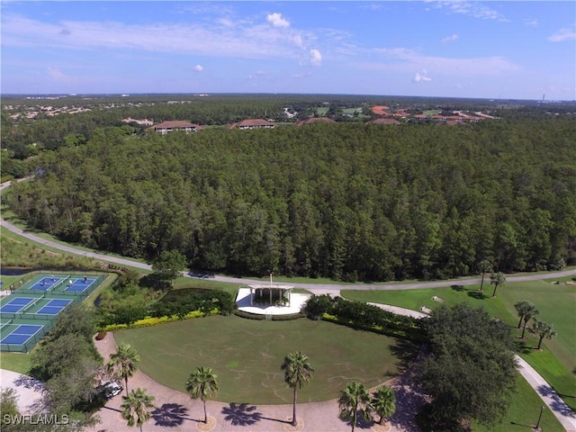 birds eye view of property with a view of trees