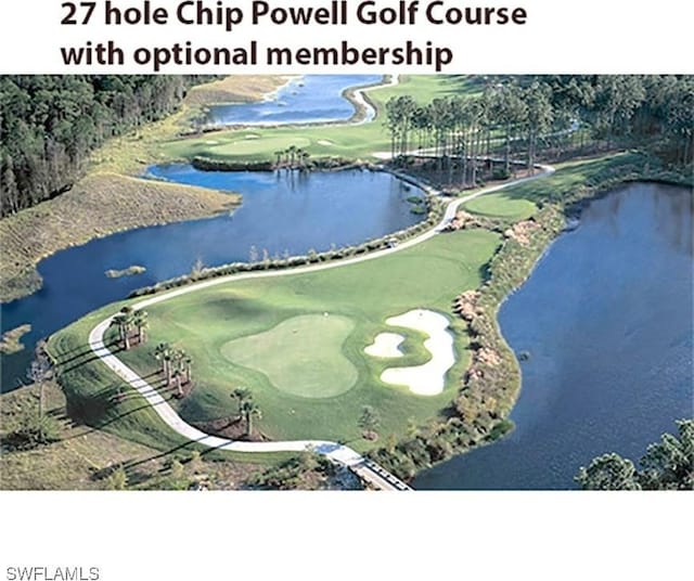 birds eye view of property with a water view and view of golf course