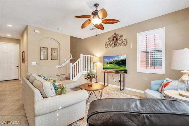 living room with light tile patterned floors and ceiling fan