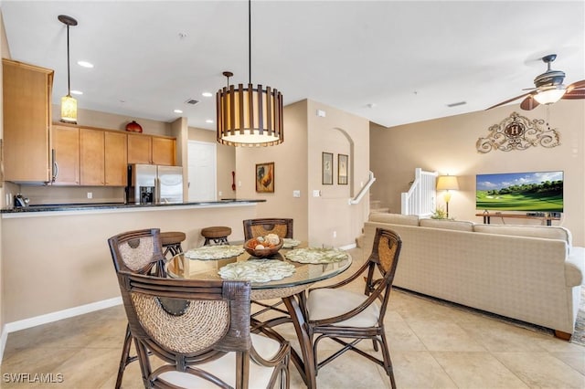 tiled dining room with ceiling fan