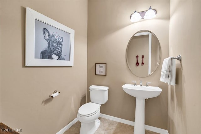 bathroom featuring tile patterned flooring and toilet