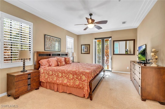 carpeted bedroom featuring french doors, ceiling fan, ornamental molding, and access to exterior