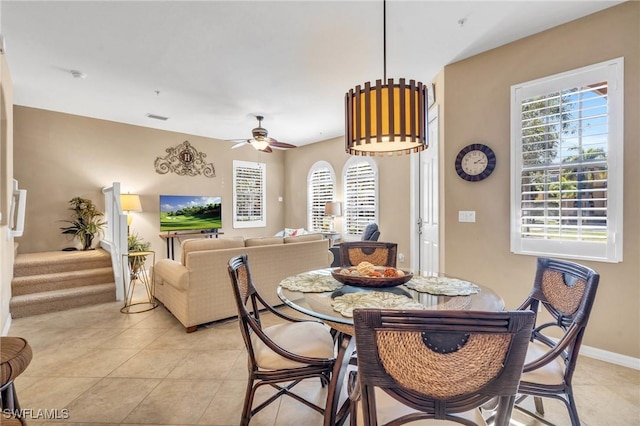 dining space with ceiling fan and light tile patterned floors