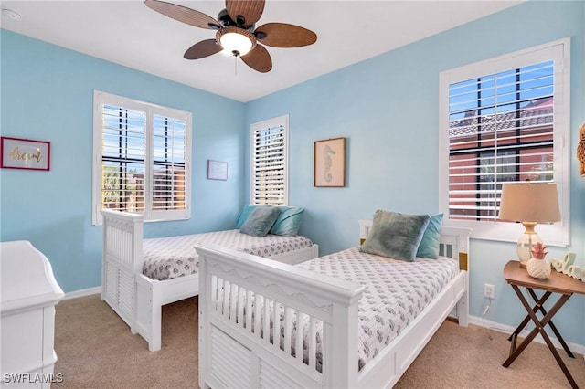 bedroom featuring ceiling fan and light colored carpet