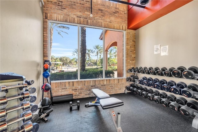 gym featuring brick wall