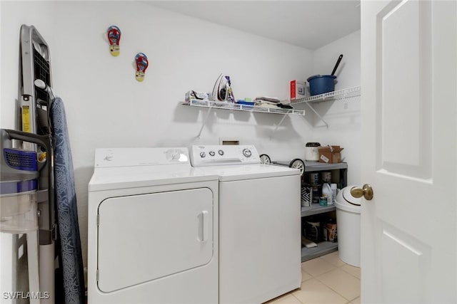 laundry room featuring washer and dryer and light tile patterned flooring