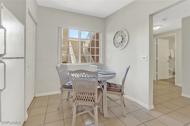 dining area featuring light tile patterned flooring