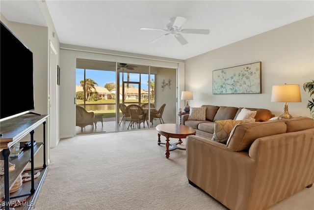 carpeted living room featuring ceiling fan