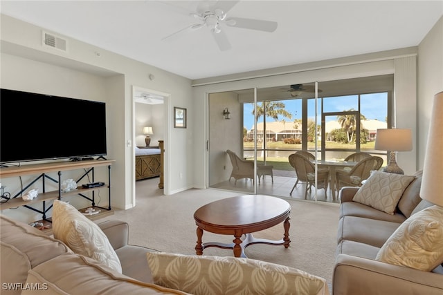 carpeted living room with ceiling fan