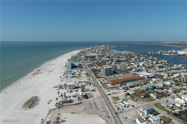 birds eye view of property with a water view and a beach view