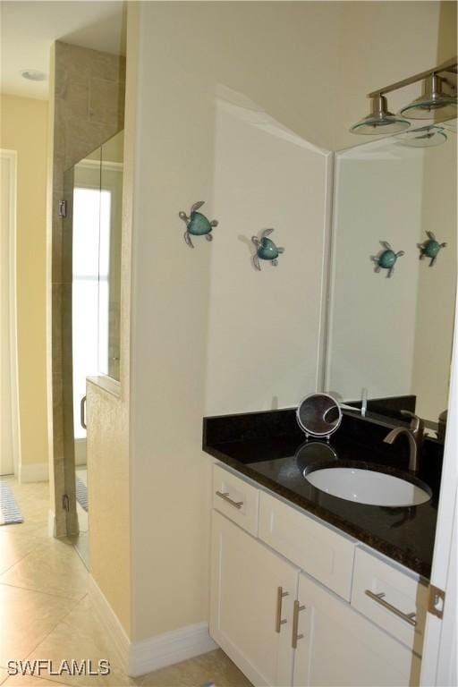 bathroom featuring vanity, tile patterned floors, and a shower with door