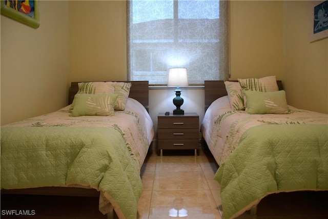 bedroom with light tile patterned floors