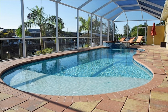 view of swimming pool with glass enclosure and a patio