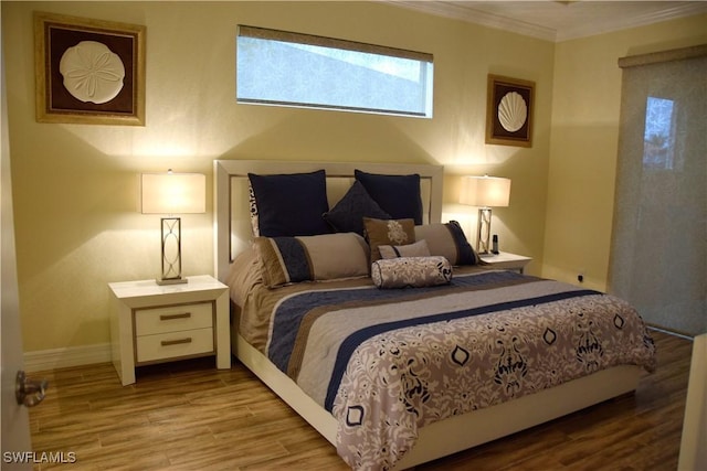 bedroom featuring light hardwood / wood-style floors and ornamental molding