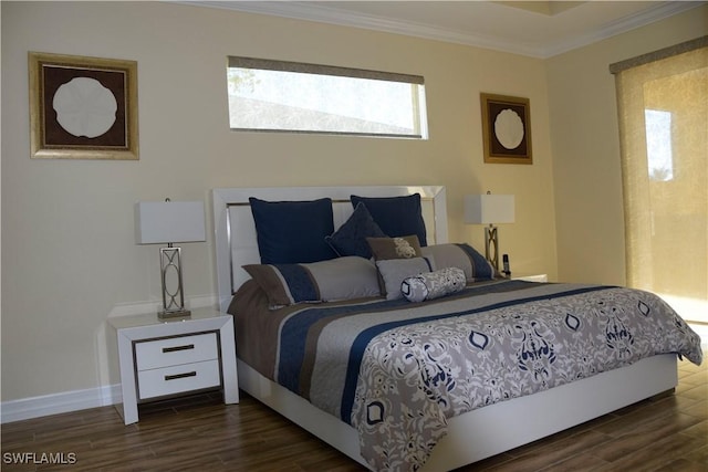 bedroom with dark hardwood / wood-style floors and ornamental molding