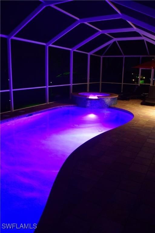 view of swimming pool featuring a lanai, an in ground hot tub, and a patio