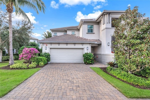 view of front of property with a front lawn and a garage