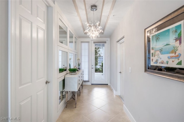 doorway with light tile patterned floors and a notable chandelier