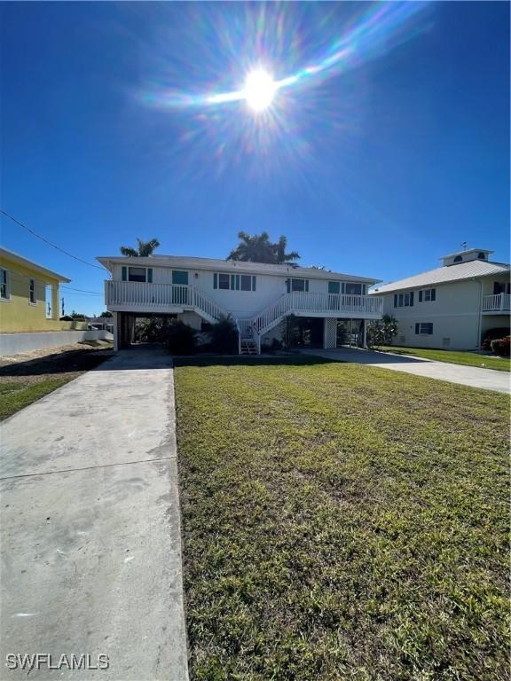4861 Regal, Bonita Springs, FL 34134 - view of front facade with a front yard and a carport