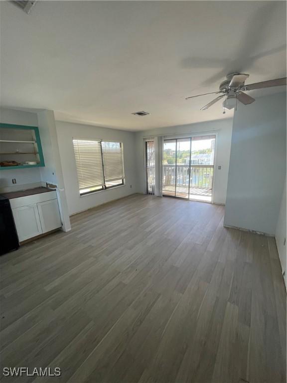 4861 Regal, Bonita Springs, FL 34134 - unfurnished living room with ceiling fan and wood-type flooring